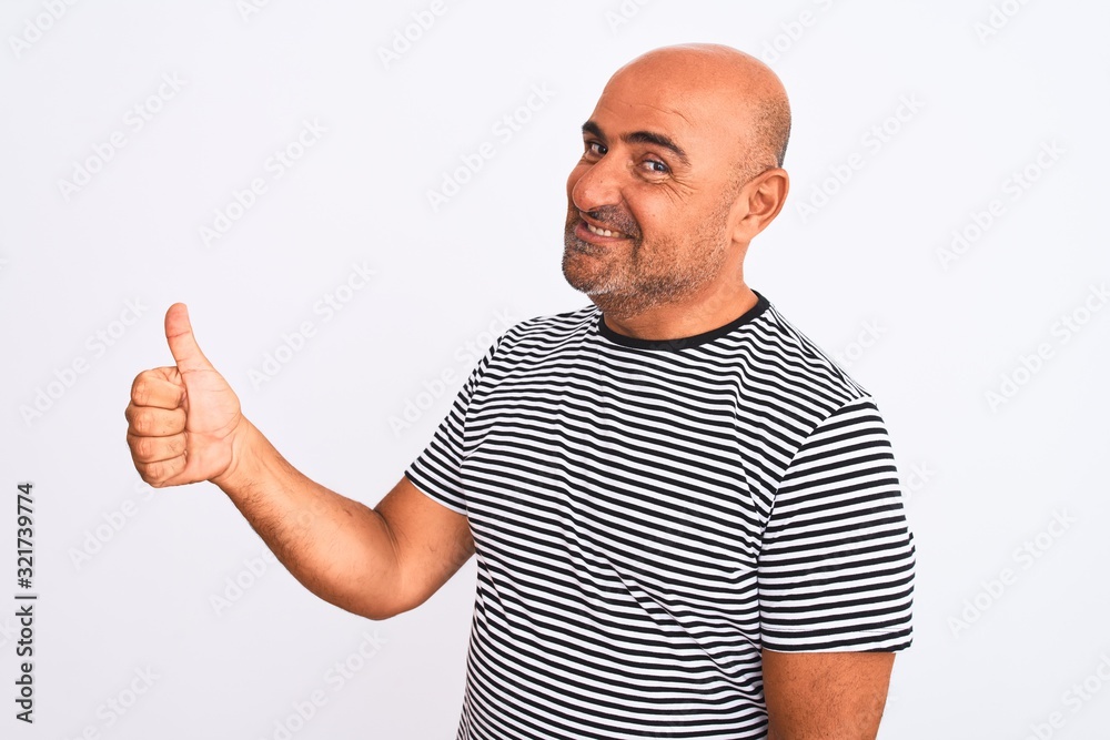 Middle age handsome man wearing striped navy t-shirt over isolated white background Looking proud, smiling doing thumbs up gesture to the side Middle age handsome man wearing striped navy t-shirt over isolated white background Looking proud, smiling doing thumbs up gesture to the side