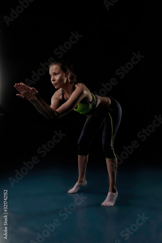 girl in sportswear is engaged in yoga in a certain position © Дмитрий Хитрин