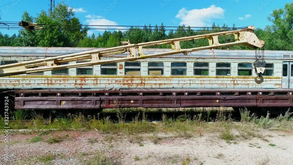 Aerial view of a dump of abandoned rusty trains and crane among the forest in city Pripyat near Chernobyl nuclear power plant. Exclusion Zone. 4K drone footage Aerial view of a dump of abandoned rusty trains and crane among the forest in city Pripyat near Chernobyl nuclear power plant. Exclusion Zone. 4K drone footage