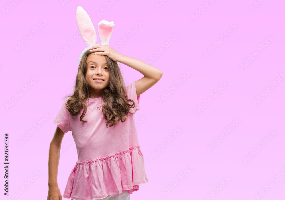Brunette hispanic girl wearing easter rabbit ears stressed with hand on head, shocked with shame and surprise face, angry and frustrated. Fear and upset for mistake. Brunette hispanic girl wearing easter rabbit ears stressed with hand on head, shocked with shame and surprise face, angry and frustrated. Fear and upset for mistake.