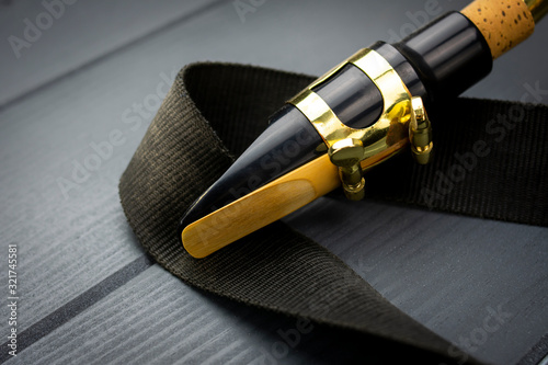 Close-up of the mouthpiece of a saxophone with its vibrating reed