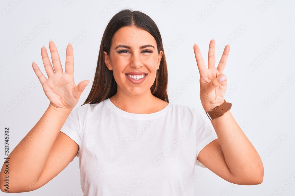 Portrait of beautiful and young brunette woman standing over isolated white background showing and pointing up with fingers number eight while smiling confident and happy. Portrait of beautiful and young brunette woman standing over isolated white background showing and pointing up with fingers number eight while smiling confident and happy.
