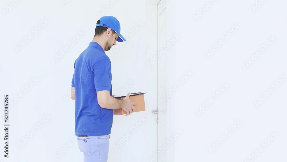 Postman giving a package to customer after signing Postman giving a package to customer after signing