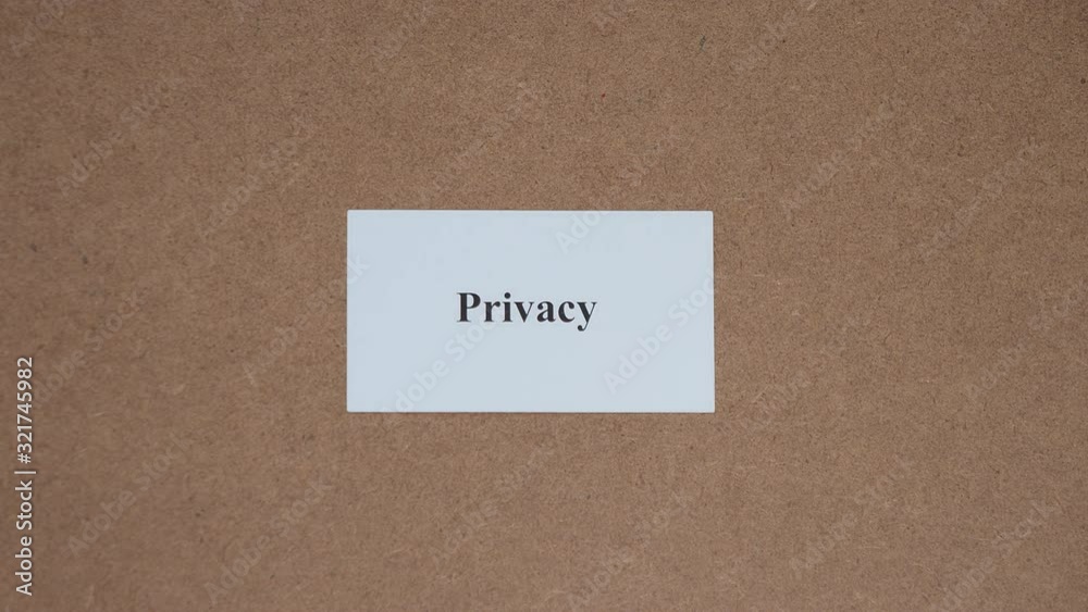 PRIVACY. Top shot - Hand puts paper card with word. CORE VALUE concept. PRIVACY. Top shot - Hand puts paper card with word. CORE VALUE concept.