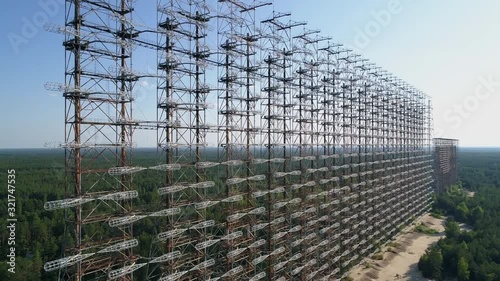 Aerial view of the DUGA radar station near the city of Chernobyl-2 among the forest. Exclusion Zone. Camera approaching. 4K drone footage. photo