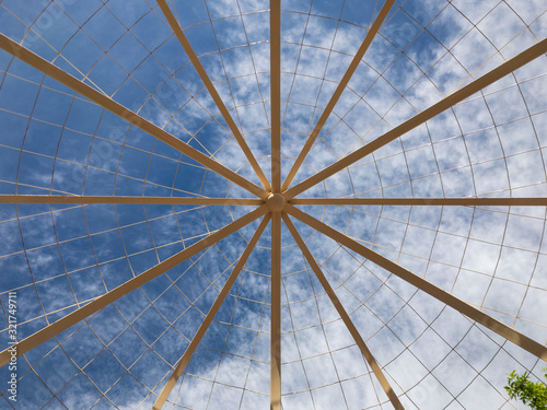 Looking Up at Blue Sky and Clouds Through a Roofless Gazebo