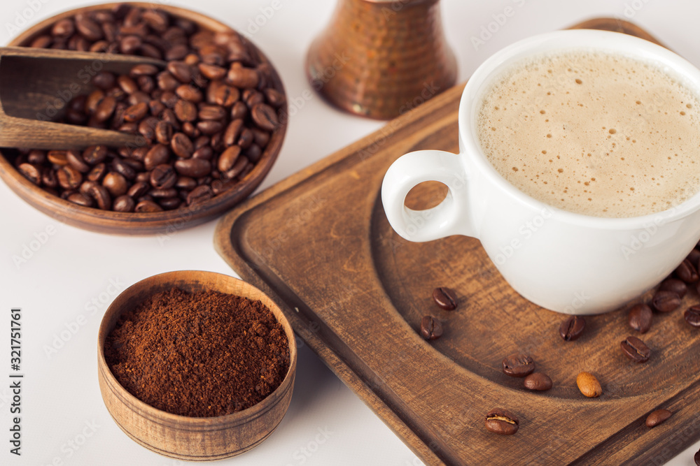 Ground coffee and coffee beans on white background