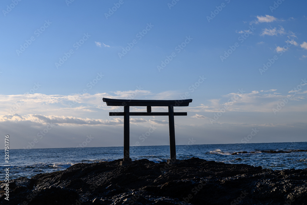Oarai Japanese white shinto torii gate in the sea