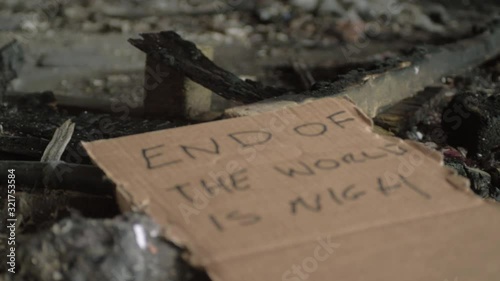 End of the world handwritten sign left in dirt and rubble