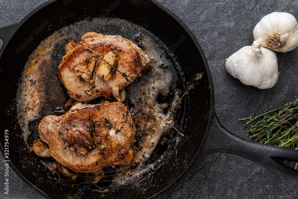 Pan Fried Pork Chops with Thyme, Garlic and Butter in a cast iron skillet Pan Fried Pork Chops with Thyme, Garlic and Butter in a cast iron skillet