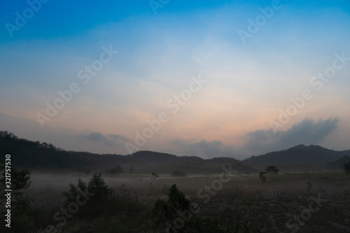 Landscape veiw of grassland and mountains with morning fog. at Khao Phu Don Rayong Thailand.