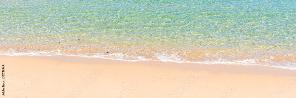 tropical beach and sea with wave reaching coast, summer travel and vacation concept, background