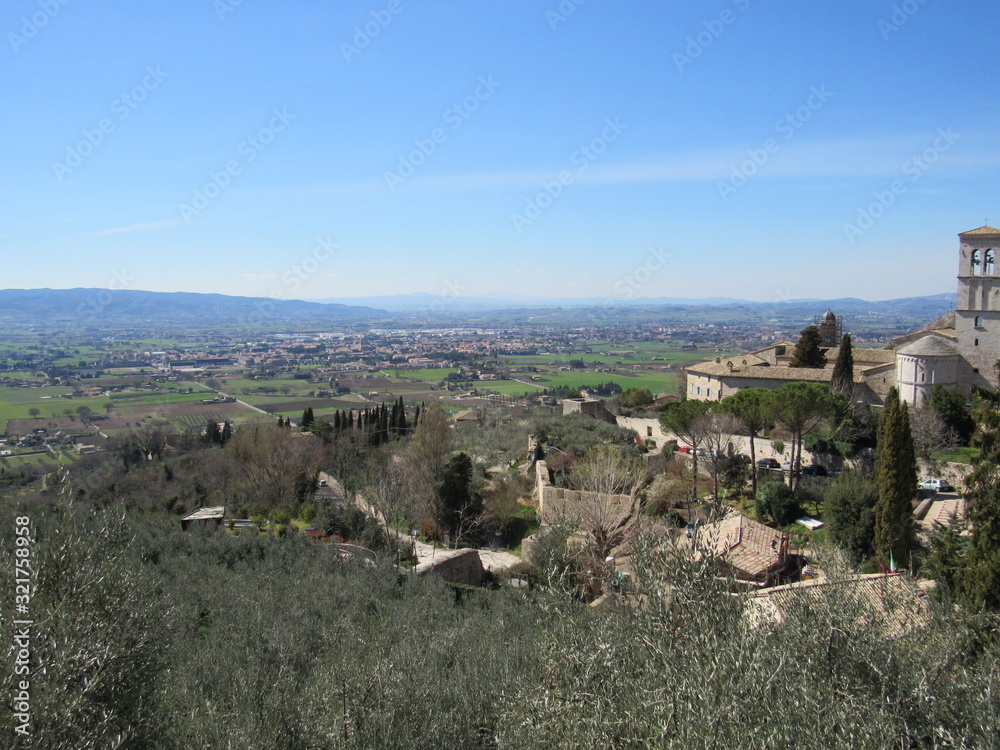 View of the landscape from Piazza Santa Chiara in Assisi, Italy with the church of Saint Mary Maggiore in view