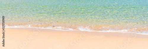 tropical beach and sea with wave reaching coast, summer travel and vacation concept, background