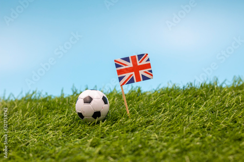 football with Union Jack Flag on green grass