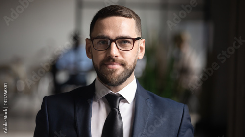Headshot portrait of businessman successful entrepreneur photoshooting standing in office
