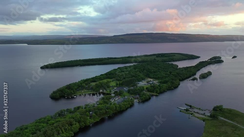 Lusty Beg Island during colorful sunset in Northern Ireland, backwards aerial photo