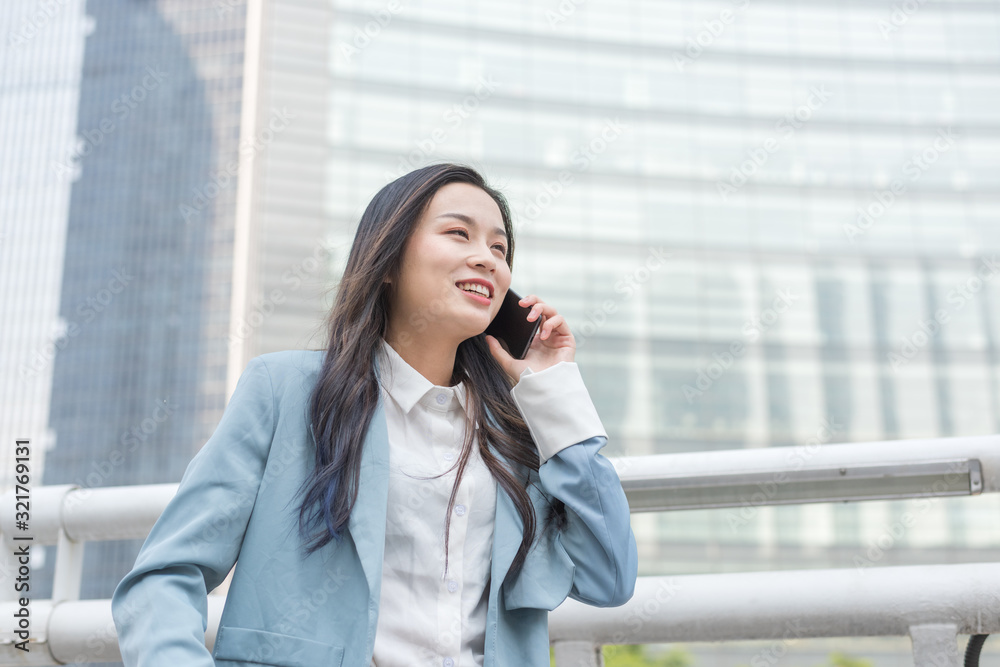 Young business women call in the business district Young business women call in the business district