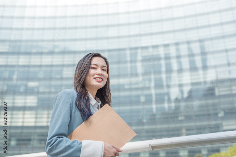 Fototapeta premium Young business lady with document bag