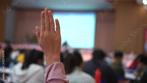 Audience or students raising hands up participation while speaker speech at seminar conference hall with crowd groups, arms of large group in classroom, Rear view of anonymous people vote or question
