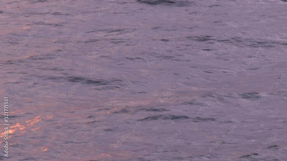 Buoy bobbing in the ocean near Dublin port as the water reflects the sunset Buoy bobbing in the ocean near Dublin port as the water reflects the sunset