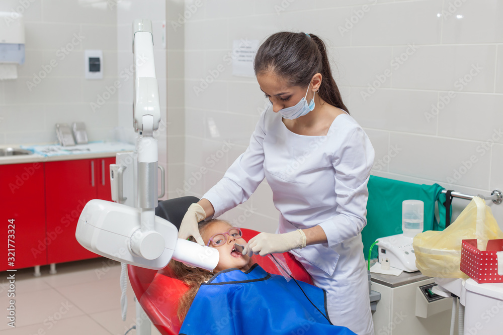 Dentist x-ray. A child with a dentist in a dental office. Dentist x-ray. A child with a dentist in a dental office.
