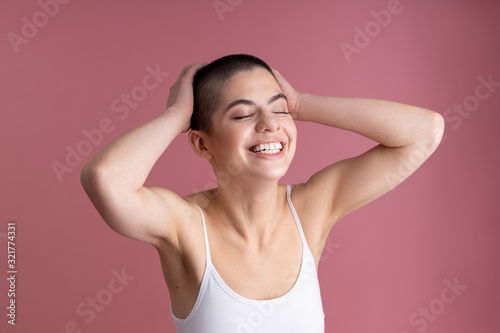 Delighted young girl feeling good and smiling stock photo