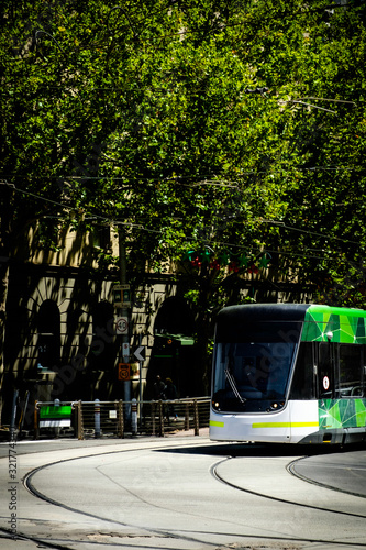 Famous Melbourne city cycle trams with tour groups at Australia