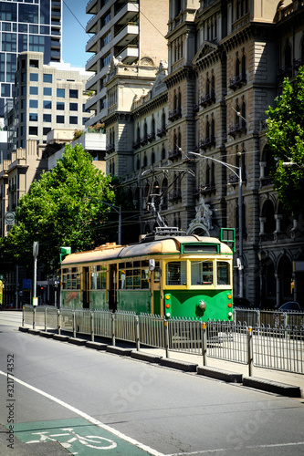 Famous Melbourne city cycle trams with tour groups at Australia