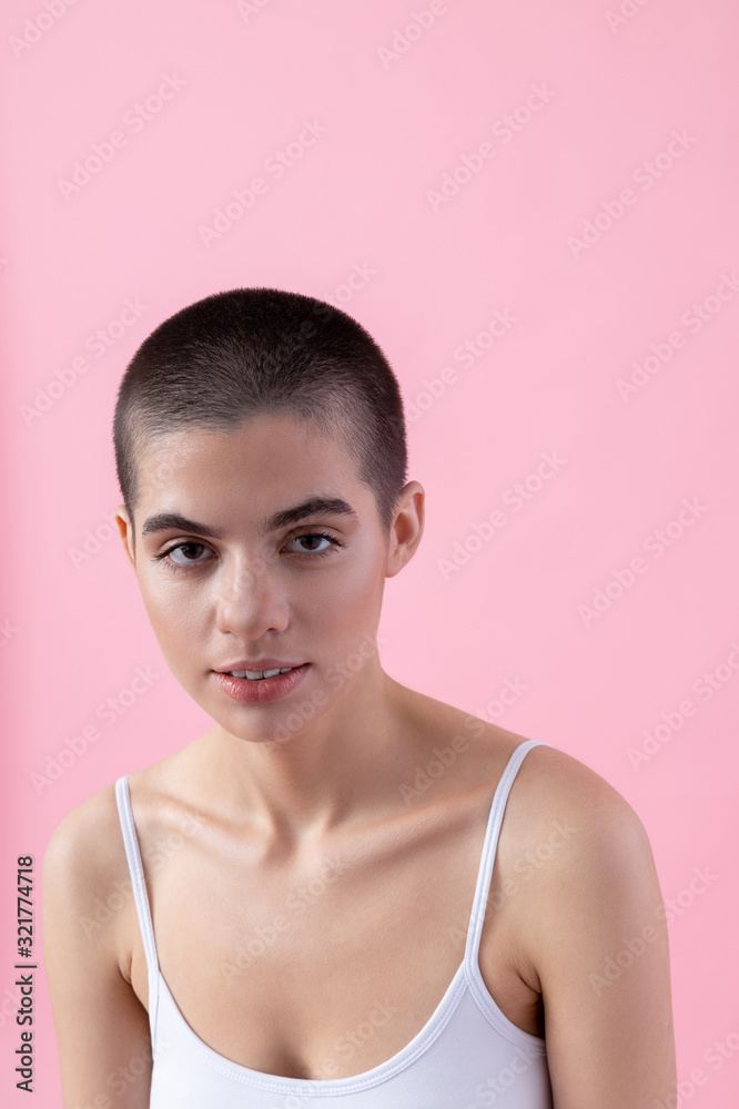 Calm young lady in soft bra on pink background stock photo Calm young lady in soft bra on pink background stock photo
