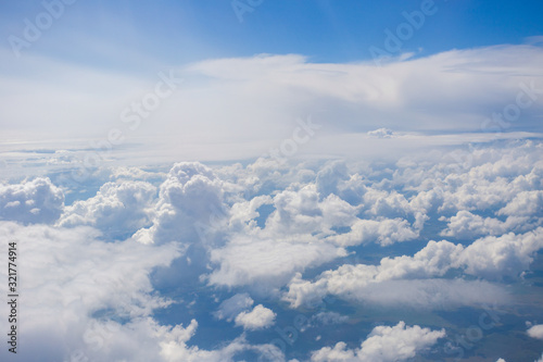 View from the porthole of an airplane. A beautiful view of the white clouds from a height of 10,000 meters.