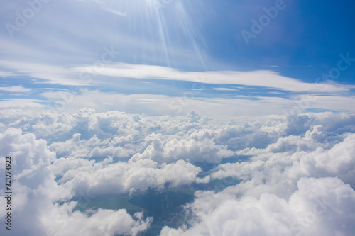 View from the porthole of an airplane. A beautiful view of the white clouds from a height of 10,000 meters. © alexhitrov