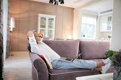 Sleepy lady on sofa in the living room stock photo