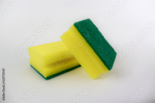 Two yellow green sponges isolated on white background