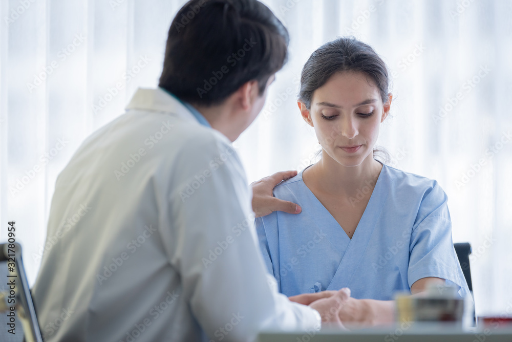 A doctor takes care of a sick patient woman with sadness and unhappiness at the hospital or medical clinic. A doctor takes care of a sick patient woman with sadness and unhappiness at the hospital or medical clinic.