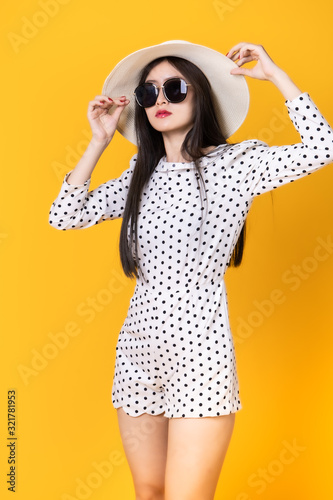 Asian woman in summer casual clothes.She smiling and  happy shopping. she  lovely attractive shine on  yellow background.Summer Surprise Sale  concept. © anon