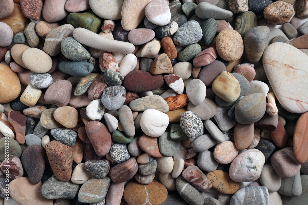Gravel pattern of colored stones. Abstract nature pebbles background.Small sea stones on the beach, vacation at sea. Top view Gravel pattern of colored stones. Abstract nature pebbles background.Small sea stones on the beach, vacation at sea. Top view