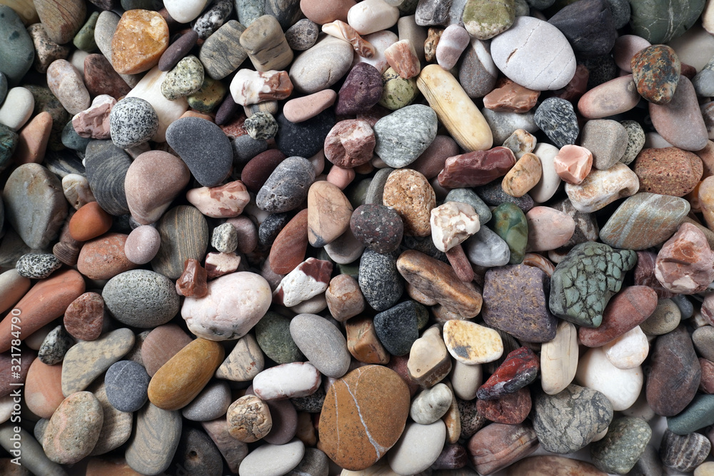 Gravel pattern of colored stones with shell. Abstract nature pebbles background.Small sea stones on the beach, vacation at sea. Top view Gravel pattern of colored stones with shell. Abstract nature pebbles background.Small sea stones on the beach, vacation at sea. Top view