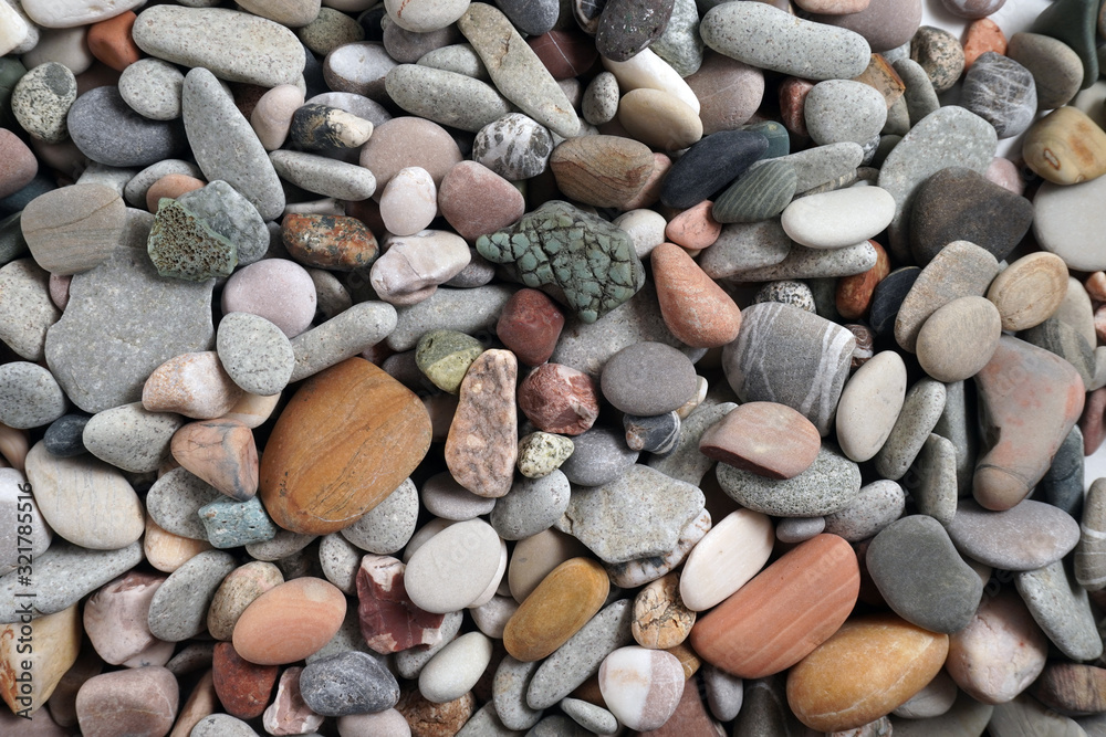 Gravel pattern of colored stones with shell. Abstract nature pebbles background.Small sea stones on the beach, vacation at sea. Top view Gravel pattern of colored stones with shell. Abstract nature pebbles background.Small sea stones on the beach, vacation at sea. Top view