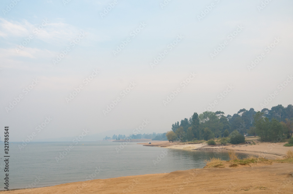 Lake Jindabyne covered in a smokey haze