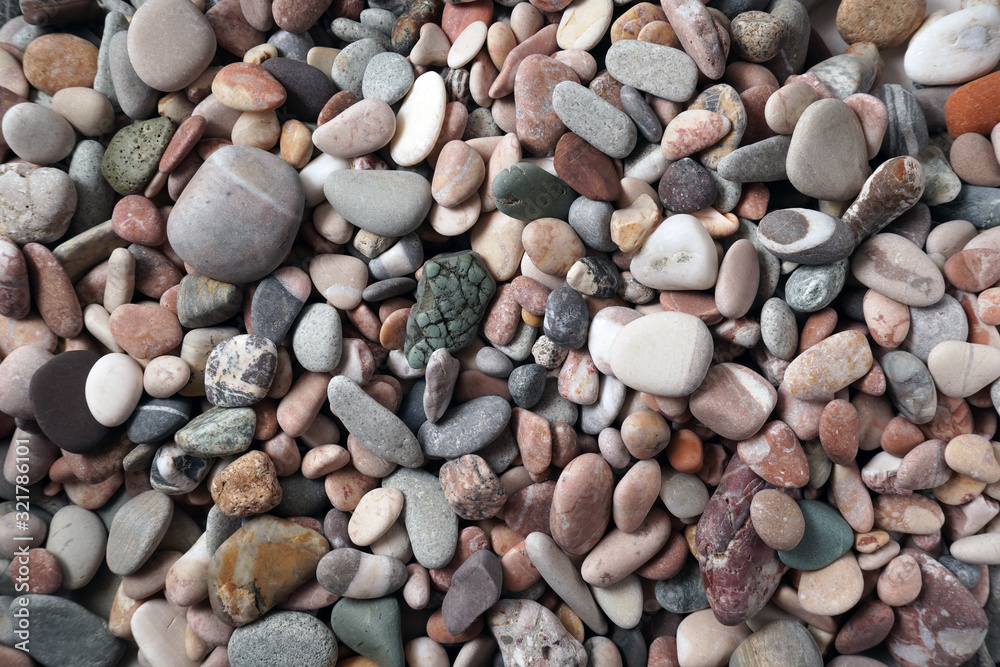 Gravel pattern of colored stones with shell. Abstract nature pebbles background.Small sea stones on the beach, vacation at sea. Top view Gravel pattern of colored stones with shell. Abstract nature pebbles background.Small sea stones on the beach, vacation at sea. Top view