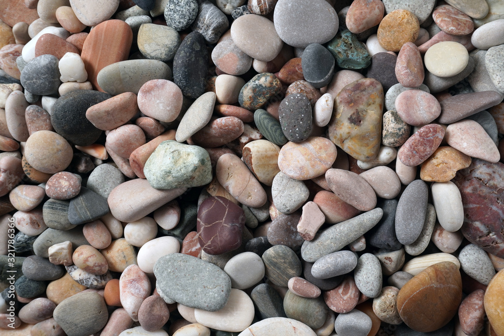 Gravel pattern of colored stones with shell. Abstract nature pebbles background.Small sea stones on the beach, vacation at sea. Top view Gravel pattern of colored stones with shell. Abstract nature pebbles background.Small sea stones on the beach, vacation at sea. Top view
