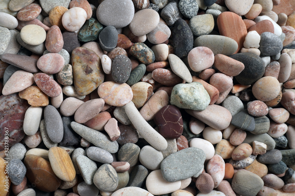 Gravel pattern of colored stones with shell. Abstract nature pebbles background.Small sea stones on the beach, vacation at sea. Top view Gravel pattern of colored stones with shell. Abstract nature pebbles background.Small sea stones on the beach, vacation at sea. Top view