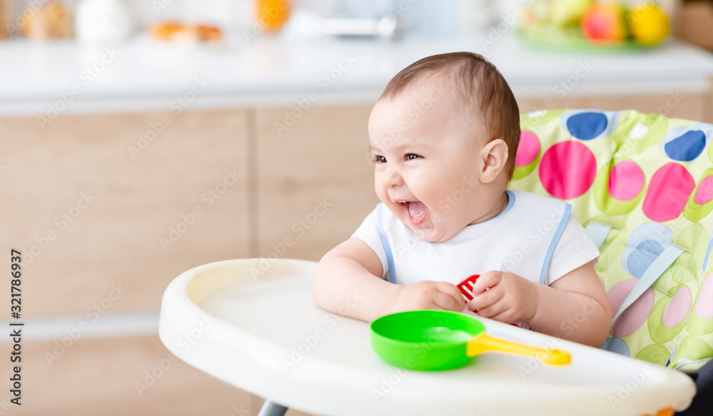 Cute baby playing with toy pan and kitchen spatula Cute baby playing with toy pan and kitchen spatula
