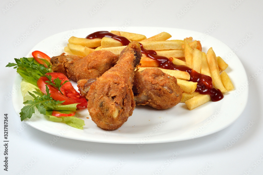 Food from a chicken restaurant with vegetables and sauce. Food from a chicken restaurant with vegetables and sauce.