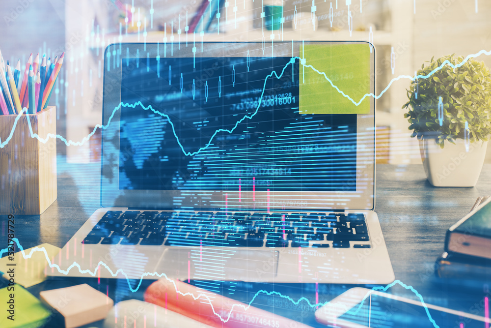 Fototapeta premium Financial graph colorful drawing and table with computer on background. Double exposure. Concept of international markets.