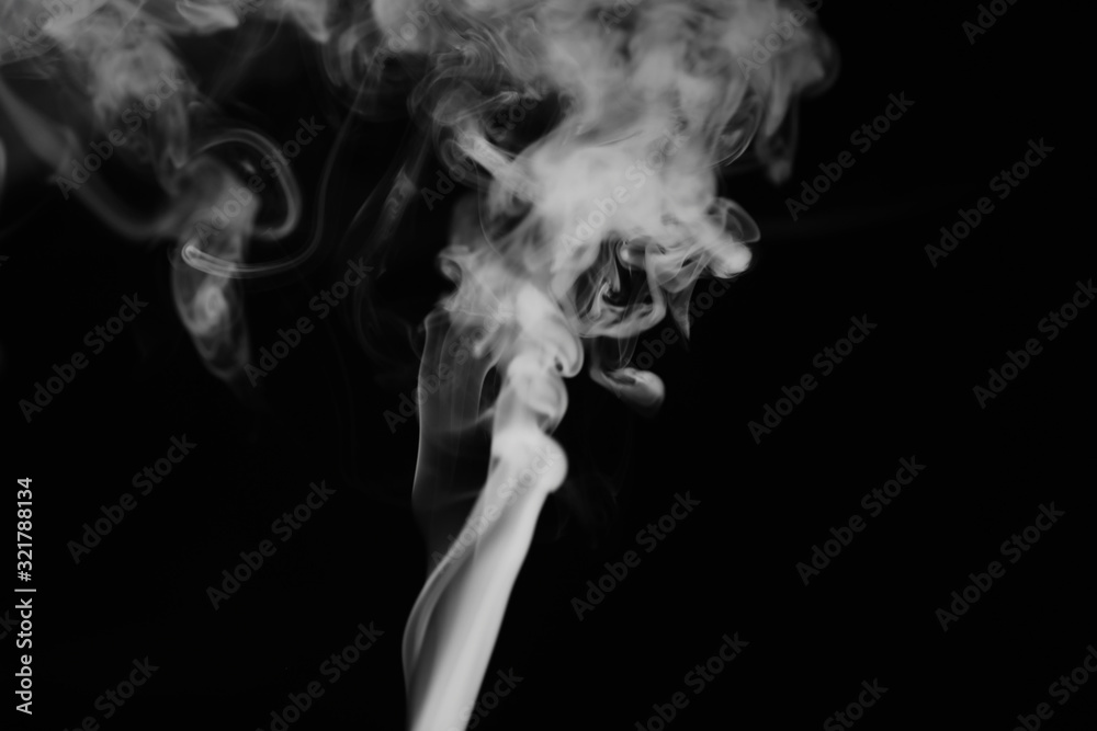 White smoke on a black background. Texture of smoke. Clubs of white smoke on a dark background for an overlay White smoke on a black background. Texture of smoke. Clubs of white smoke on a dark background for an overlay