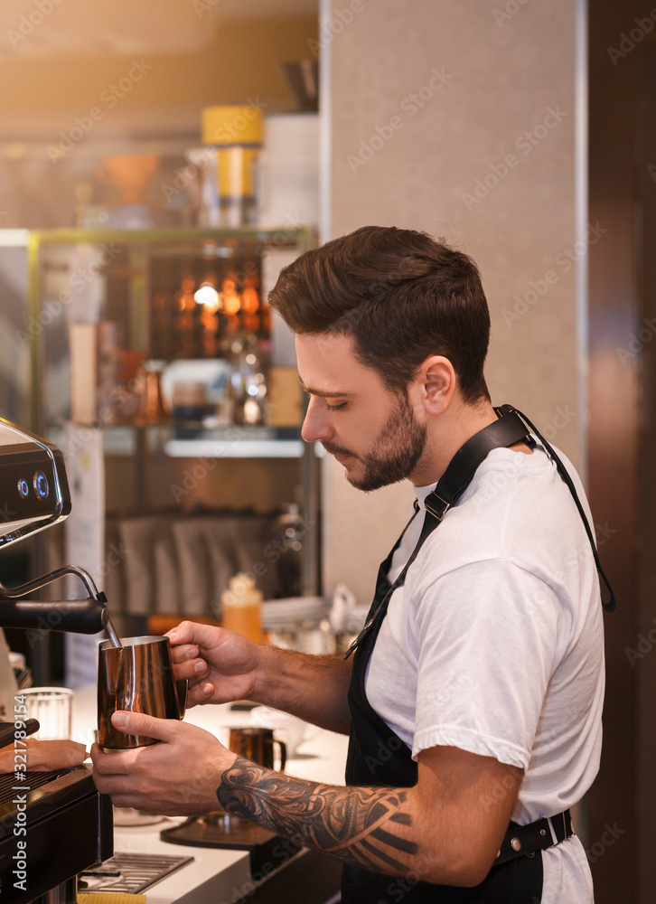 Fototapeta premium Professional Barista Making Coffee Using Coffee-Machine Standing In Cafe