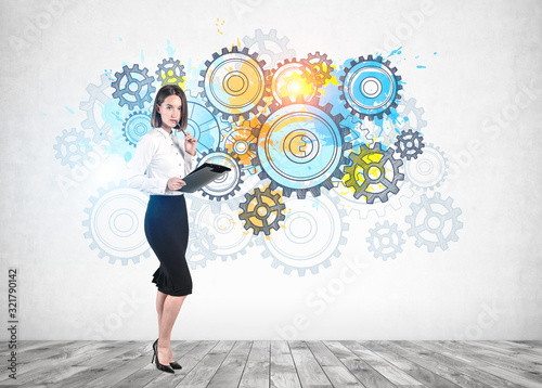 Woman with clipboard and gears as team concept