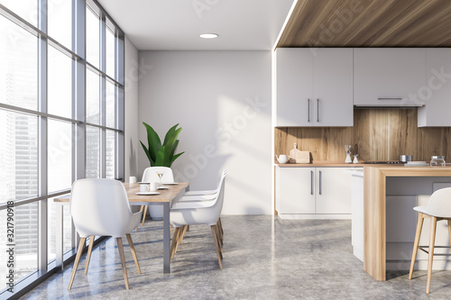 White and wooden kitchen with dining table © ImageFlow